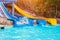 Senior woman having fun on water slide in hotel aquapark