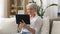 Senior woman having video chat on tablet pc