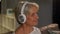 Senior woman in headphones listening to music