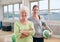 Senior woman at health club with gym instructor