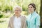 Senior woman and helpful caregiver, nursing home concept photos