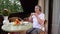 Senior woman with her coffee on terrace in summertime