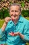 Senior woman in her garden and homegrown redcurrants