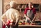 Senior woman hiding gift box for her husband at kitchen