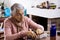 Senior woman at home arranging her prescription drugs into a weekly pill organizer