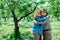 Senior woman hugging happy retired husband in straw hat