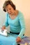 Senior woman ironing