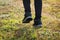 Senior woman jogger jogging in the morning in nature trail, close-up shot on legs and dirty shoes