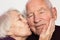 The senior woman kissing old man