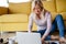 Senior woman with laptop indoors at home, relaxing.