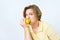 Senior woman with lemon in hand doing funky action. An elderly woman is eating a lemon. She is on a diet. She is looking