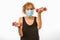 Senior Woman Lifting Dumbbells & Wearing Face Mask During Corona Virus Epidemic Lifting Two Pound Dumbbells For Exercise