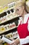 Senior woman looking at can in retail store