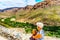 Senior woman looking at the completely dry Huisrivier along the Huis River Pass on highway 62 between Ladismith and Calitzdorp