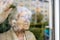 Senior woman looking out of window