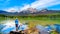 Senior woman looking at Pyramid Mountain in Pyramid Lake in Jasper National Park