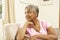 Senior Woman Looking Thoughtful In Chair