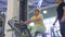 Senior woman makes pull up exercise on training apparatus in the gym