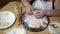 Senior woman making dumplings with mashed potatoes stuffing