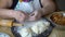 Senior woman making dumplings with roasted cabbage in ukrainian way
