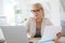 Senior woman making paperwork at office