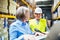 Senior woman manager and man worker working in a warehouse.