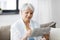 Senior woman marking newspaper ad at home