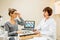 Senior woman ophthalmologist with patient in the office