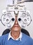 Senior woman patient, eye test and phoropter in hospital, optometrist office or clinic for vision healthcare. Optician