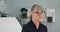 Senior woman patient sitting in medical exam room waiting for the doctor