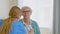 Senior woman patient undergoes examining with stethoscope and doctor listens to heartbeat