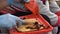 Senior woman peeling peppers for seasonal winter pepper sauce