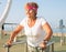 Senior woman performing parallel bar exercises on beach