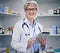 Senior woman, pharmacist and tablet portrait with medical stock and digital research. Pharmacy, healthcare store and