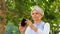 Senior woman photographing at summer park