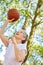 Senior woman playing basketball as a vital pensioner