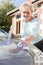 Senior Woman Polishing Car With Cloth