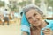 Senior woman at pool with towel