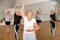 Senior woman practicing classical ballet technique in choreography class