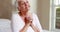 Senior woman praying in bed