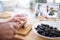 Senior woman preparing food in kitchen indoors, following food vlogger.