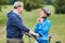 Senior woman puts on a bicycle helmet