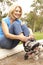 Senior Woman Putting On In Line Skates In Park