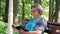 Senior woman reading bible in the park