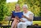 Senior woman reading book in park.