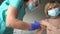Senior woman receiving vaccine. Medical worker vaccinating an elderly patient against flu, influenza, pneumonia or