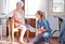 Senior woman, rehabilitation and help for foot injury, disability or pain in nursing home. Physiotherapist, doctor and