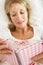Senior Woman Relaxing In Bed Reading Diary