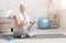 Senior woman resting on exercise mat after fitness workout