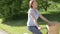 Senior Woman Riding Bike Along Country Track